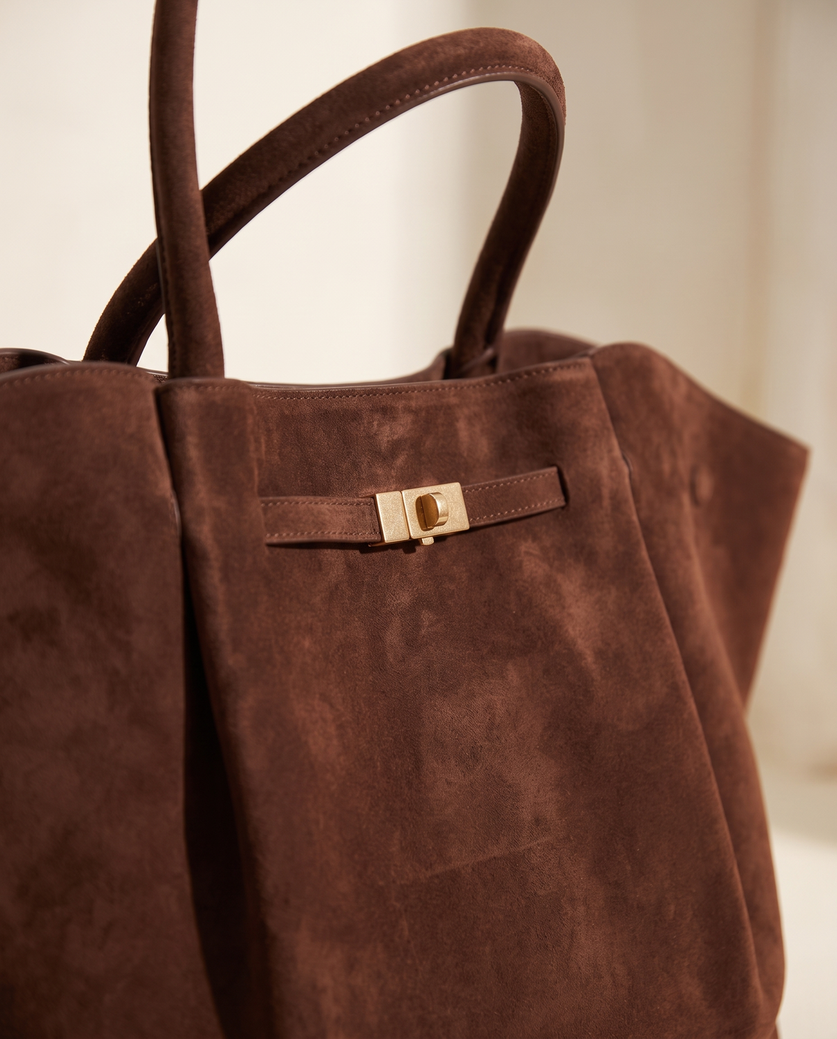 Gold turn-lock detail on the Moka suede Large Tote